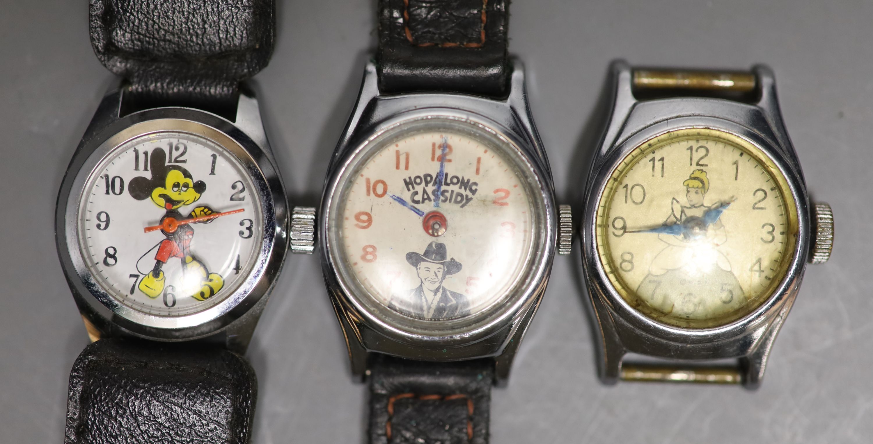 Three assorted small size steel wrist watches, including Mickey Mouse, Hopalong Cassidy and Cinderella.